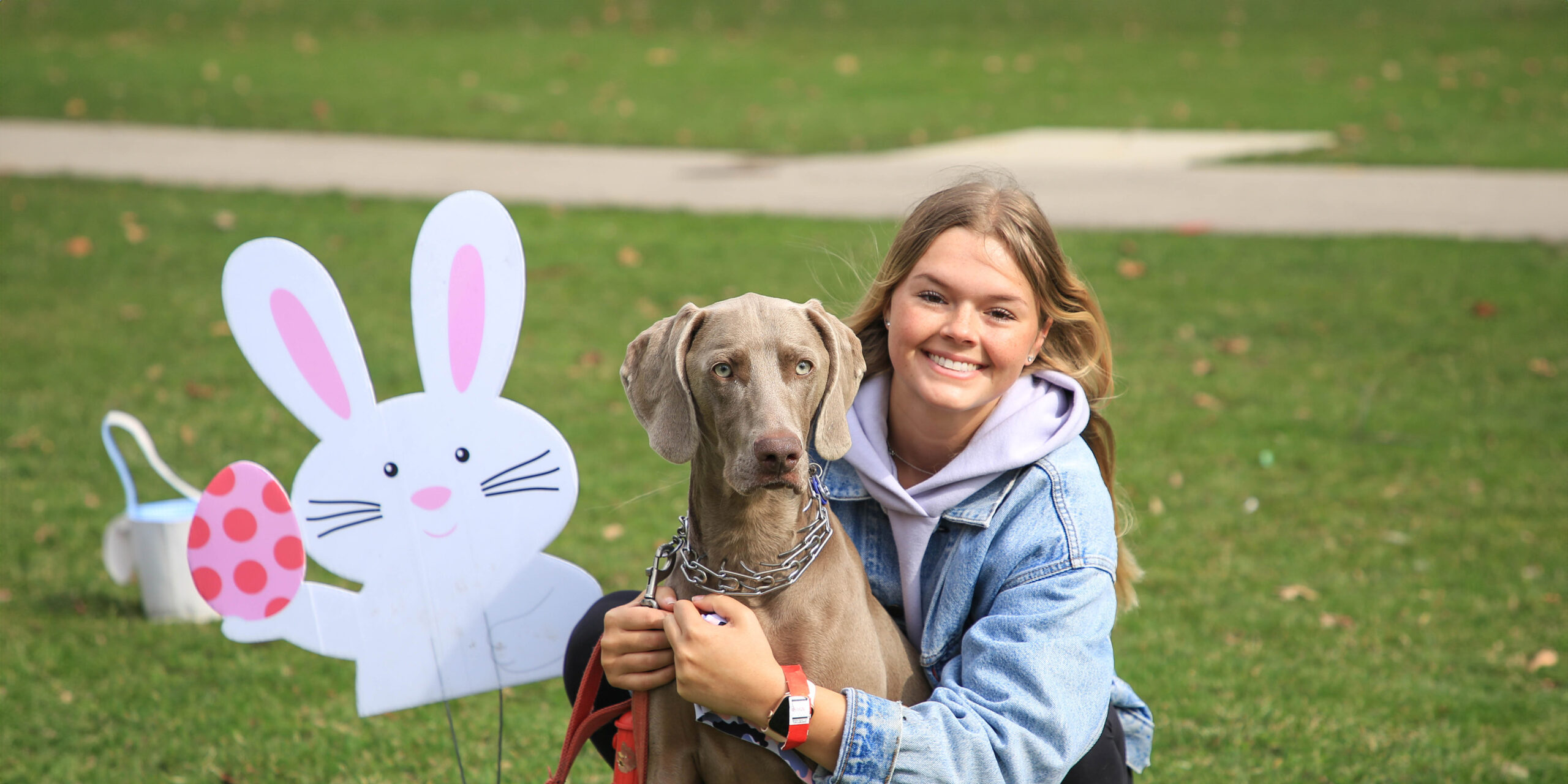 Woman and her dog in the park for spring celebration.